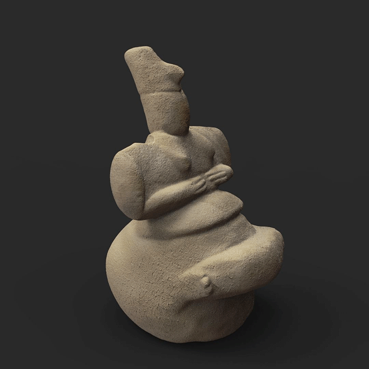 An ancient Late Neolithic Cycladic marble figurine of a seated woman with crossed legs and hands resting on her belly.